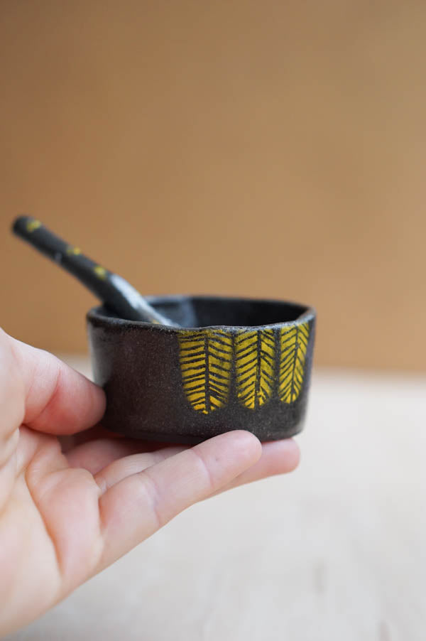 A spice jar with a tiny spon