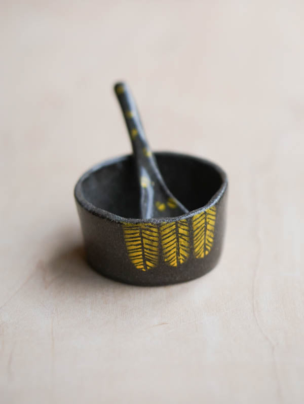 A spice jar with a tiny spon