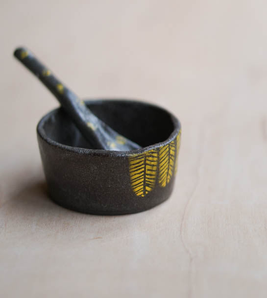 A spice jar with a tiny spon